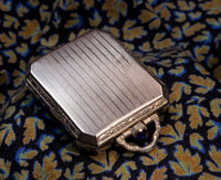 Elgin Art Deco Travel Clock/Pendant - Faceted Rectangular Case - Gilt Perlage Interior – Blue Cabochon Release - Early 1930s